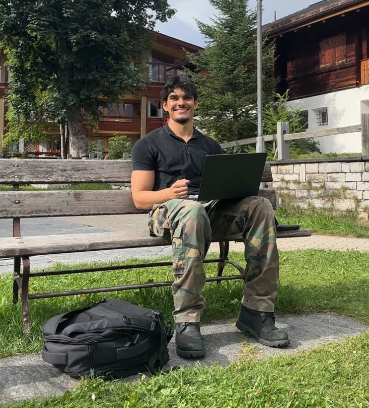 Harrison McMurdie sitting outdoors with his laptop